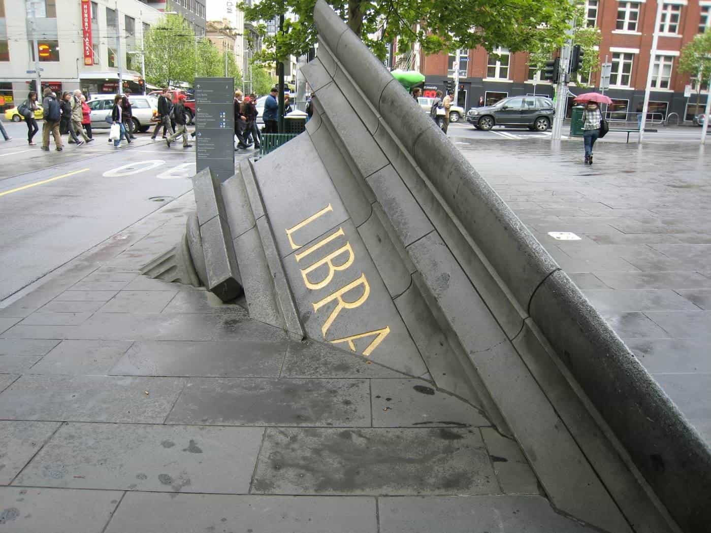 A bluestone sculpture rising from the footpath on Swanston Street, Melbourne