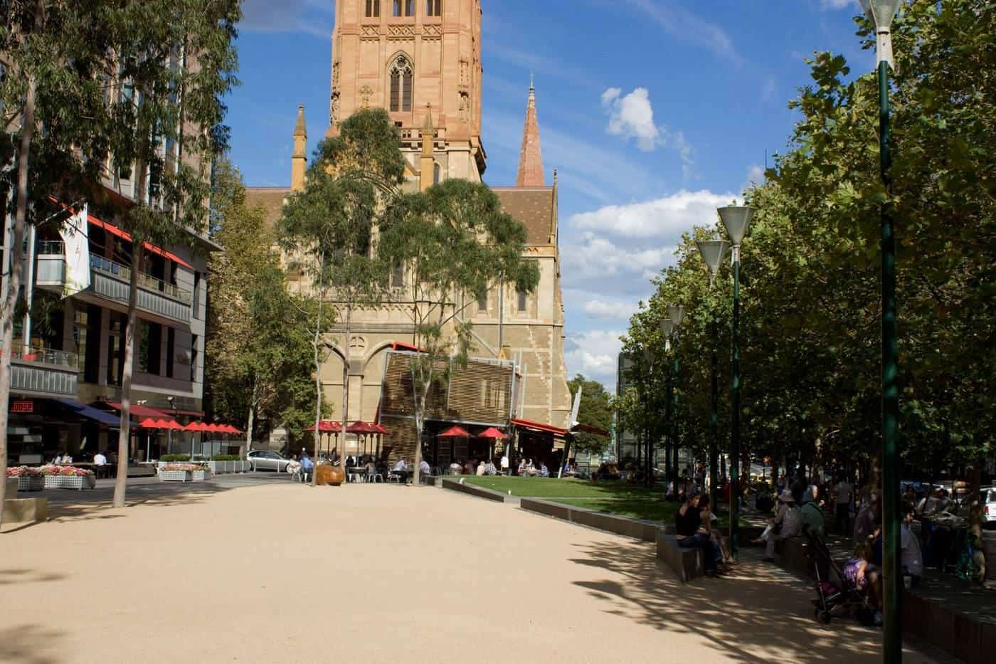 City Square in Melbourne with paved open space, trees and a cathedral spire behind