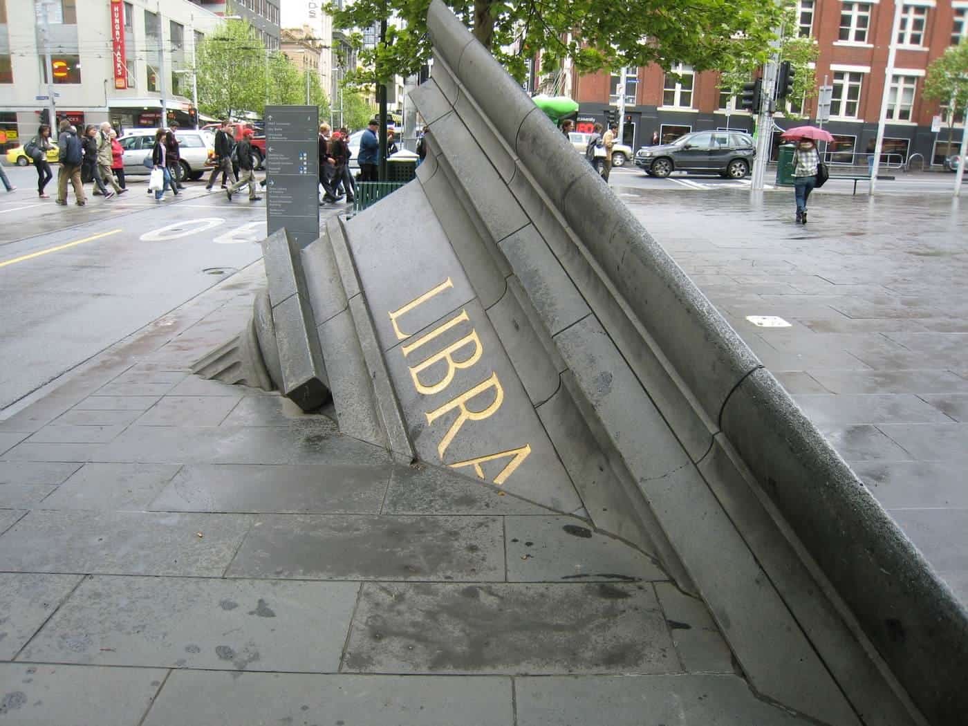 A bluestone sculpture rising from the footpath on Swanston Street, Melbourne